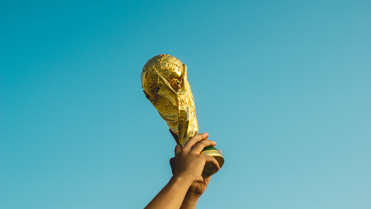 The FIFA World Cup trophy being help up